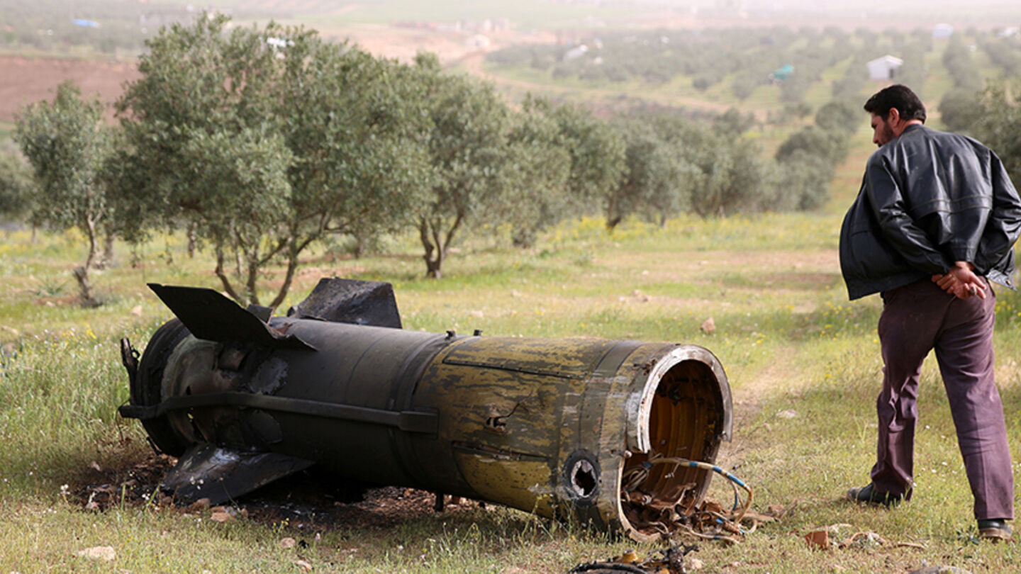 A man inspects a piece of a rocket that landed south of Daraa Al-Balad, Syria, April 5, 2017. REUTERS/Alaa Al-Faqir - RTX348K8